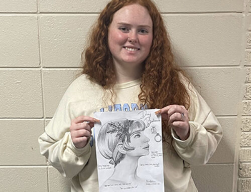 Shelby Lang shows off her art talents in Vardaman class