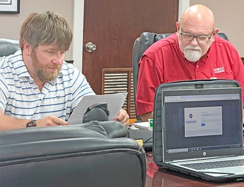 Superintendent informs school board of test scores, audit, recognition of employees